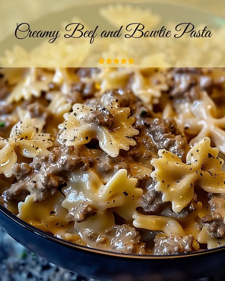 Creamy beef and bowtie pasta dish topped with herbs.