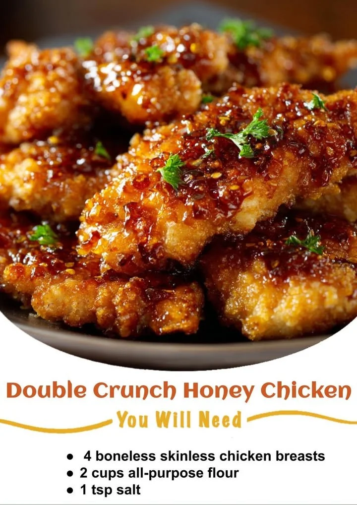 Plate of Double Crunch Honey Garlic Chicken with garnishes on a wooden table